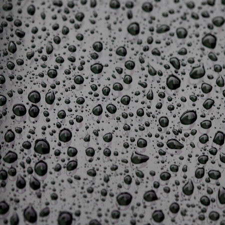 Water drops on the glass , close up , macro , black texture background , wall paperの写真素材