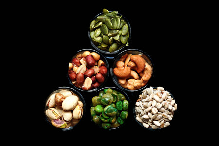 Mix Nut in the glass on gray background , close up , peanut; Peas; Sunflower seeds; Pumpkin seeds; cashew nuts; pistachiosの写真素材