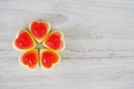 Red heart candy on wooden background with copy spaceの写真素材
