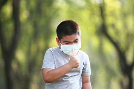 A young Asian boy wear mask to protect against dust PM 2.5 and germs