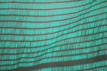 Close-up of a netting on a green background. Horizontal photoの写真素材