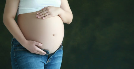 Tummy of pregnancy woman with hands hold