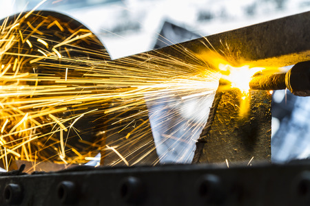 the worker cutting steel with an industrial cutter.の写真素材