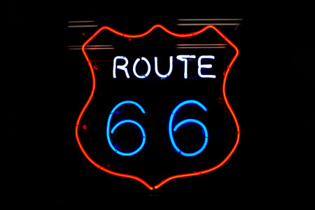 Route 66 Neon sigh with Red White and Blue colors against a dark background.