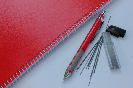 Red notebook and Mechanical pencil with pencil leadの写真素材