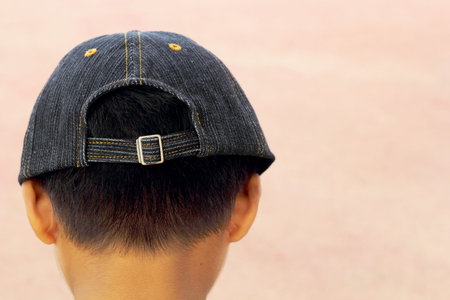 A boy wearing a hat, then turned back.