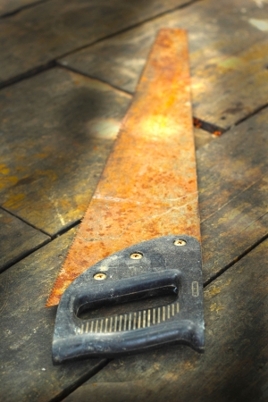 old rusty saw on the wooden backgroundの写真素材
