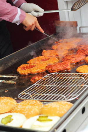 Fried steak on a hot pan on the market.
