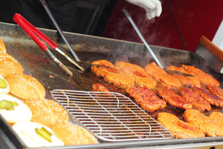 Fried steak on a hot pan on the market.