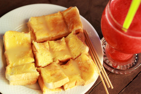 Bread and butter and strawberry smoothie.