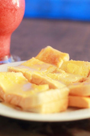 Bread and butter and strawberry smoothie.