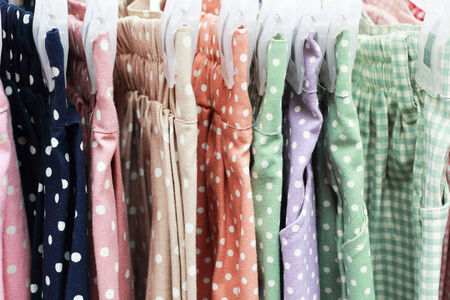 Shop pants hanging on a rack market の写真素材