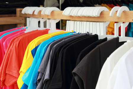 Shop shirts colorful fabric hanging on a rack.の写真素材