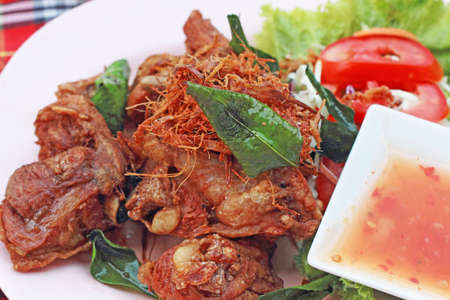 Lemongrass chicken in a dish with sauce.の写真素材