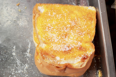 Toast with butter and sprinkling with sugar.