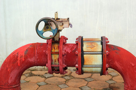 red rusty metal industrial water pipes with a valve.の写真素材