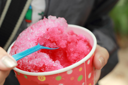girl  young eating strawberry smoothie.の写真素材