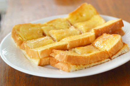 Toast with butter and sprinkling with sugar.