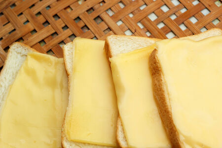 cheese the place on a slice of bread.の写真素材