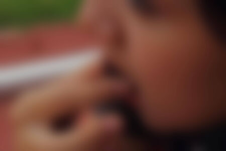 Blured young girl eating the chocolate ballの写真素材