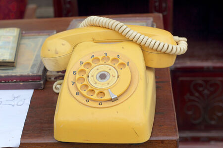 old phone vintage style on the wooden floor.の写真素材