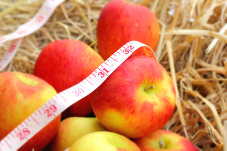 measure tape and red appleの写真素材