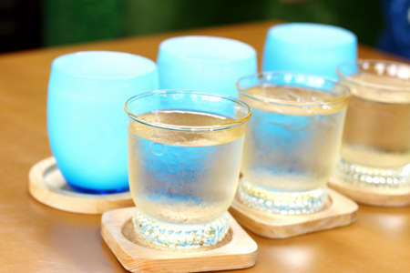 Blue glass of water on tableの写真素材