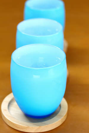 Blue glass of water on tableの写真素材