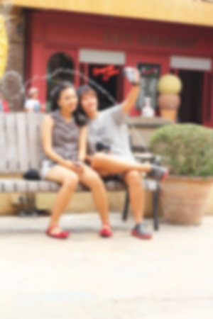 Blurred of love couple using cameraの写真素材