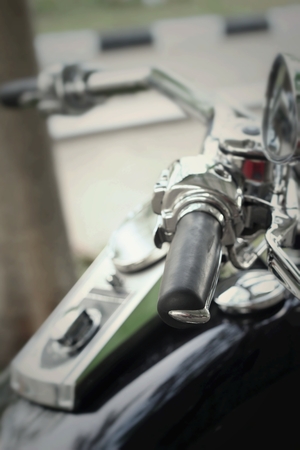 Vintage motorcycle handlebar on the roadの写真素材