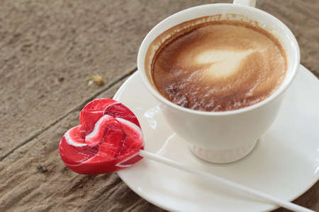 Hot latte coffee in glass and candy sweet valentines heartの写真素材