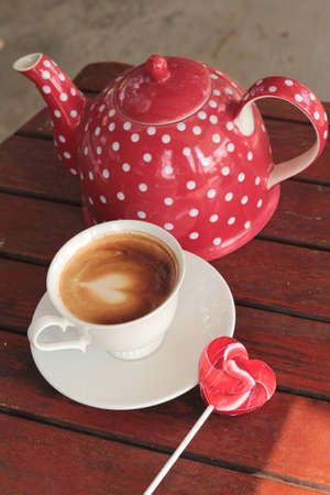 Hot latte coffee in glass and candy sweet valentines heartの写真素材