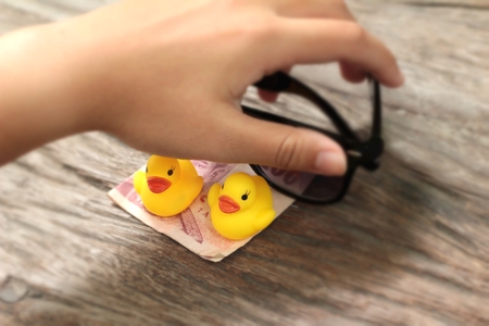 yellow rubber duck and black sunglassesの写真素材