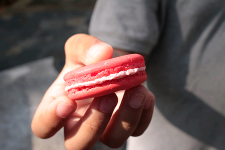 Kid eating Macaroons colorful deliciousの写真素材