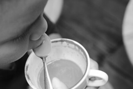 The boy is drinking green tea and milk.の写真素材