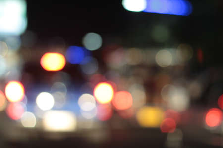 Blurred bokeh of car in city at nightの写真素材
