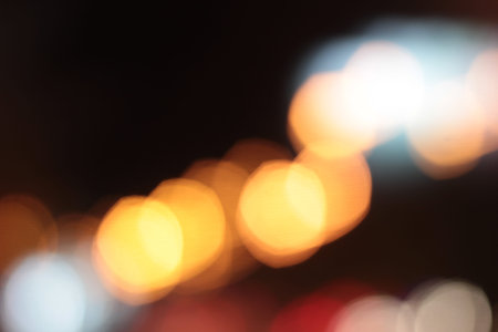 Blurred bokeh of car in city at night
