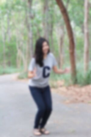 Blurred woman cheerfully at the parkの写真素材