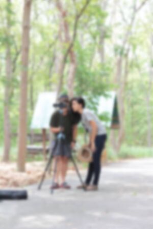 Blurred people using the camera at the park.の写真素材