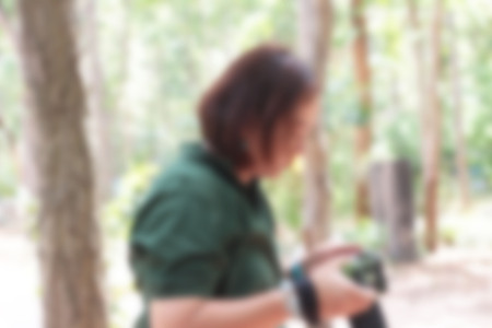 Blurred people using the camera at the park.の写真素材