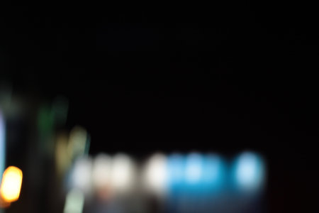 Blurred bokeh of car in city at night.