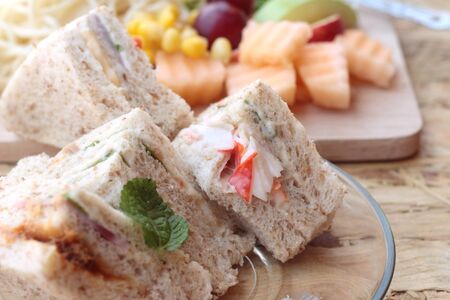 Club sandwich and pasta spaghetti with salad mix fruitの写真素材