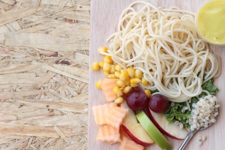 Pasta spaghetti with salad mix fruit.の写真素材