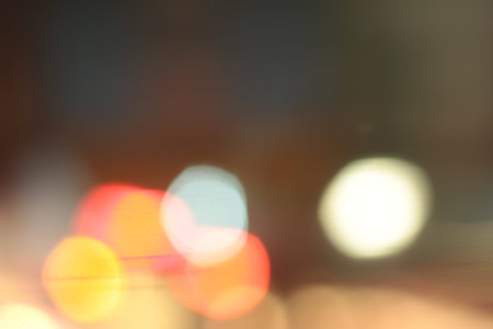 Blurred bokeh of car in city at night