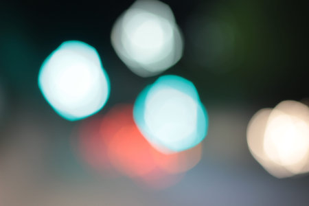 Blurred bokeh of car in city at night.
