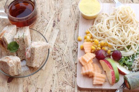Pasta spaghetti with salad mix fruit and bread sandwich.の写真素材