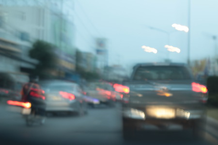 Blurred bokeh of car in city at nightの写真素材