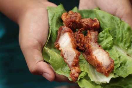 Pork fried with vegetables in handの写真素材