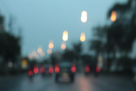 Blurred bokeh of car in city at nightの写真素材
