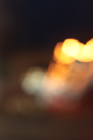 Blurred bokeh of car in city at nightの写真素材